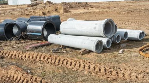 Construction site showcasing various diameters of polyethylene and concrete.. Stock Photos