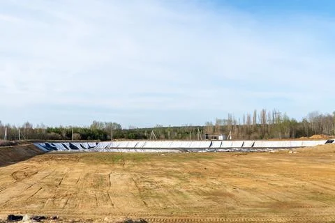 Construction Site Showing Empty Land With Protective Covering and Machinery.. Foto stock