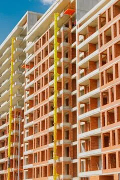 Construction site showing progress on a multi-story building with brickwork.. Stock Photos