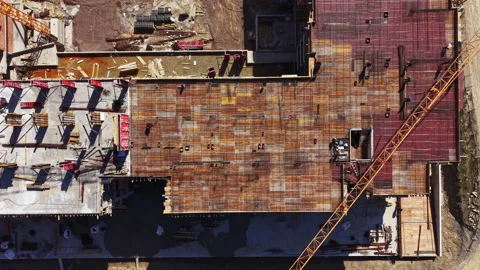 Construction site shows building progress with a flat roof and crane at work in Stock Footage 331330856
