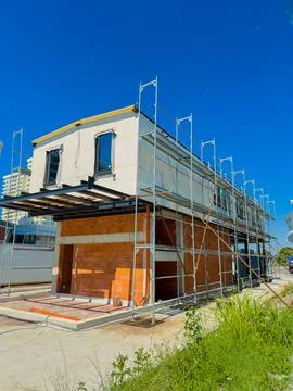 Construction site shows a building under development with scaffolding and b.. Stock Photos
