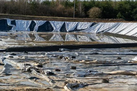 Construction Site Shows Large Pond Lined With Tarps and Gravel at an Earthw.. Stock Photos
