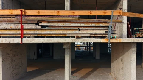 A construction site shows a large stack of building materials resting on beams Stock Footage 326679118