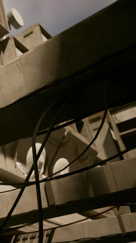 Construction site shows structure from below with cables and pipes visible Stock Footage 339410181
