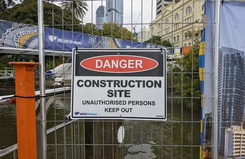 Construction site signage warning of danger on the Brisbane River. Stock Photos