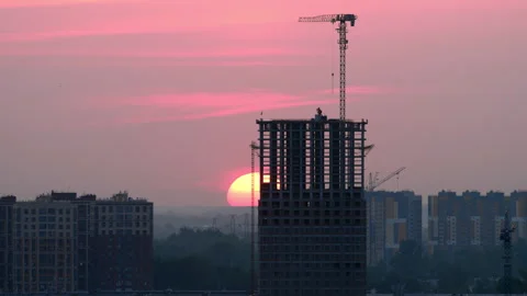 Construction site skyscraper building silhouette at sunrise time lapse Stock Footage 345013961