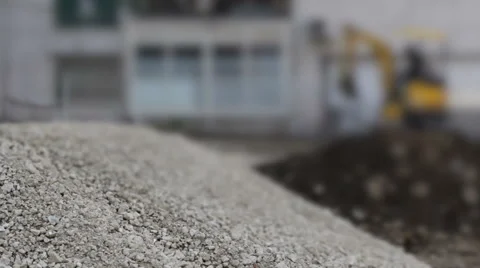 Construction site with a small backhoe moving in a de-focused background Video stock 43191681