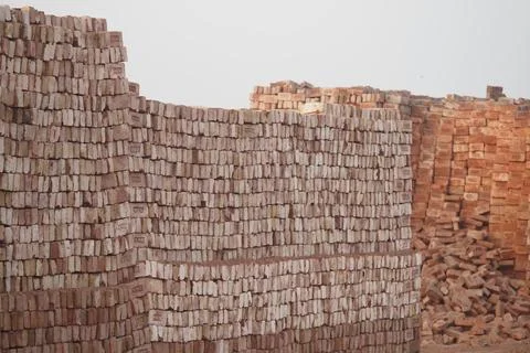 Construction site with stacked bricks ready for building projects Stock Photos