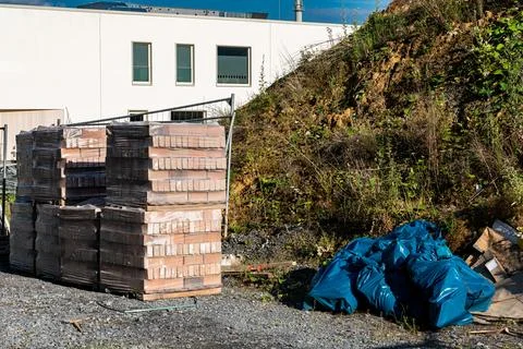 Construction site with stacked materials and waste in the bags. Stock Photos