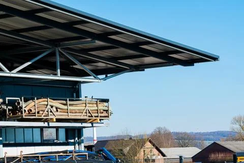 Construction site with stacked materials under clear blue sky Stock Photos