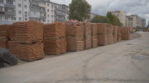 Construction site with stacks of bricks neatly arranged on pallets 動画素材 303150482