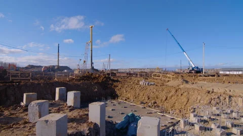 Construction site at the stage of initial earthwork, piles are now being driven  Stock Footage 161953319