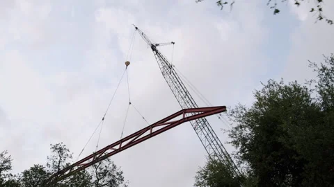 Construction Site Steel Beam Craned In The Sky 4K 48FPS SLO-MO Stock Footage 265802432