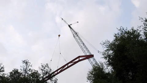 Construction Site Steel Beam Craned In The Sky Reveal 4K 48FPS SLO-MO Stock Footage 265802499