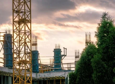 Construction site at sunset. Building under construction under crimson sky. Stock-Fotos