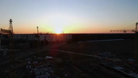 Construction site at sunset, construction cranes on the background of sunset, Stock Footage 211366057