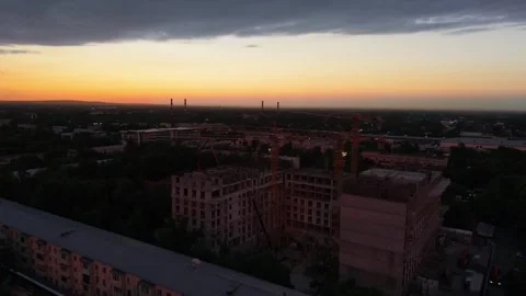 Construction site at sunset with cranes and buildings under development Stock Footage 339124080