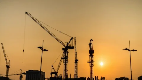 Construction Site At Sunset Time Lapse. Working Tower Cranes. Video stock 100370048