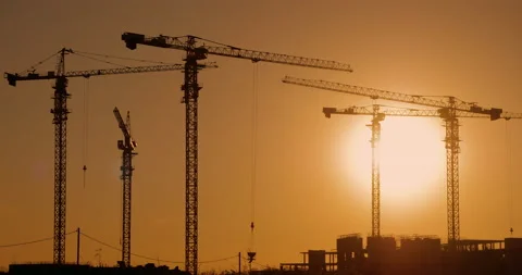 Construction site at sunset, timelapse. Cranes works on building site Stock Footage 136174709