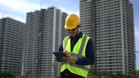 Construction Site Supervisor: A construction worker in a safety vest and ha.. Stock Footage 297598552