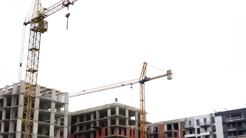 A construction site with tall cranes and partially built apartment buildings Stock Footage 317933155
