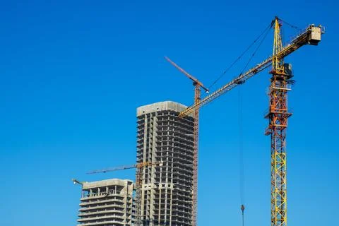 At a construction site, there is a bright blue sky in the background Stock Photos
