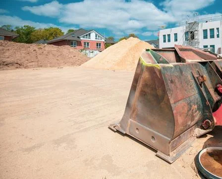 On a construction site there is a wheel loader with a shovel Stock Photos