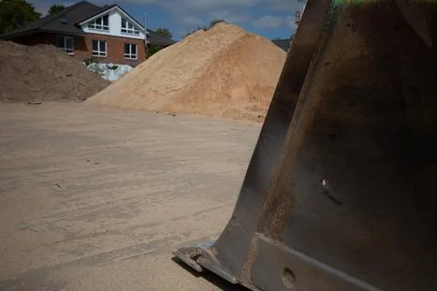 On a construction site there is a wheel loader with a shovel Stock Photos