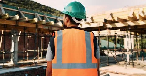 Construction site, thinking and back of man for inspection, planning and Stock Photos