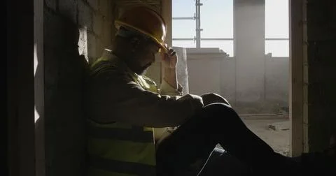Construction site, thinking or man with safety, sad or overwhelmed with mai.. Stock Photos