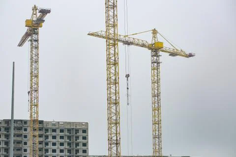 The Construction site with three cranes against the background of the evening Stock Photos