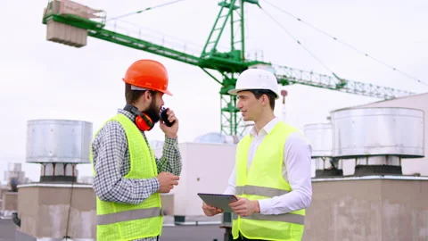 On the construction site on the top of the building engineer guy and main Stock Footage 138204722