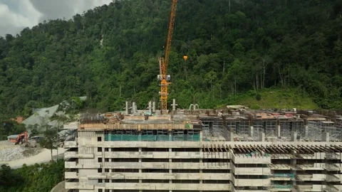 Construction Site with Tower Crane and Building Under Development Surrounded by Stock Footage 316450379