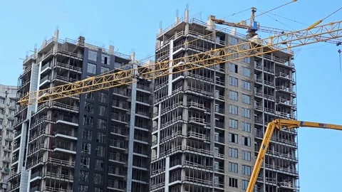 Construction site with tower cranes and unfinished high-rise buildings Stock Footage 297615031