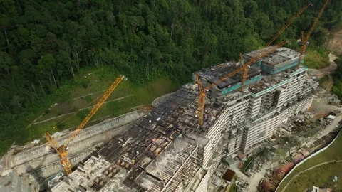 Construction Site with Tower Cranes and Forest Landscape Under Development in Stock Footage 316450397