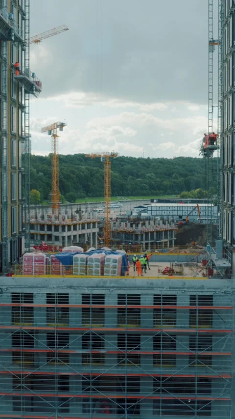 Construction site with tower cranes and workers between high-rise buildings Vídeos de archivo 318090454