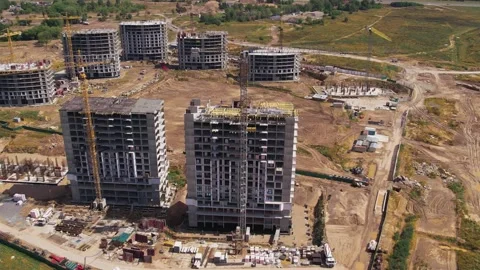Construction site tower cranes, monolithic frame houses, aerial panorama Stock Footage 158617953