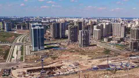 Construction site tower cranes, monolithic frame houses, aerial panorama Stock Footage 158619575