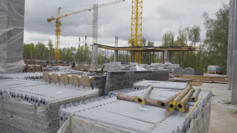Construction site with tower cranes over stacks of materials Stock Footage 303146456