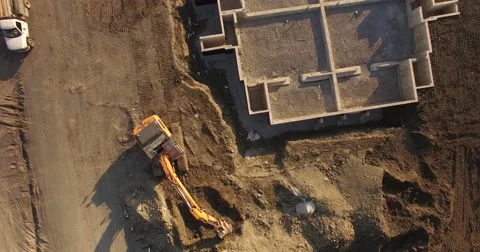 Construction site tracking shot with backhoe Stock Footage 56703608