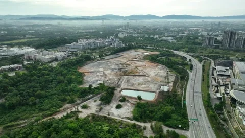 Construction site transformation surrounding greenery and highway Stock Footage 311987445