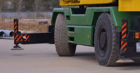 At a construction site, a truck crane is preparing to lift a load Stock Footage 147633850