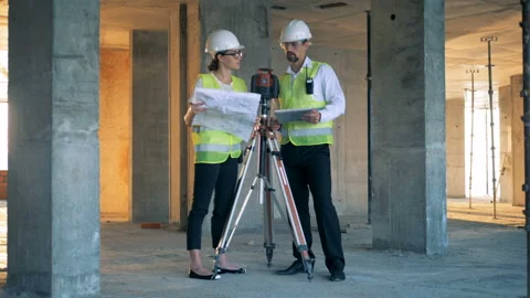 Construction site with two architects discussing something near land surveying 库存影片 95681100