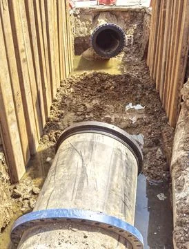 Construction site: two pipes inside a trench. The scene highlights the infr.. Stock Photos