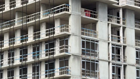 Construction site of unfinished building with concrete frames and glass win.. Stock Footage 323714361