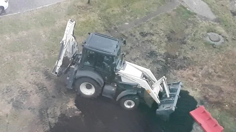 Construction site video, excavator digging, backhoe loader, excavation work. Stock Footage 129469251