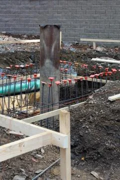 Construction site view with drain and sewage pipes and steel rebar Stock Photos