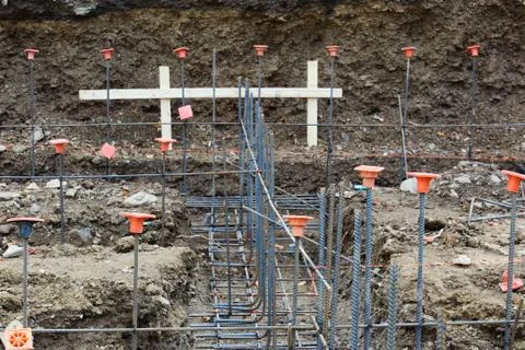 Construction site view looking down footings with gridwork of rebar Stock Photos