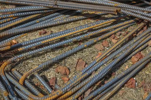 Construction site view of pile of bent steel rebar on the ground Stock Photos