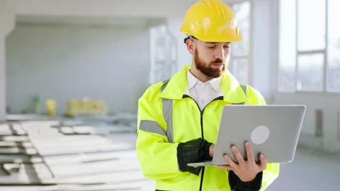 At construction site walking to the camera and working at laptop at the same Stock Footage 170141380